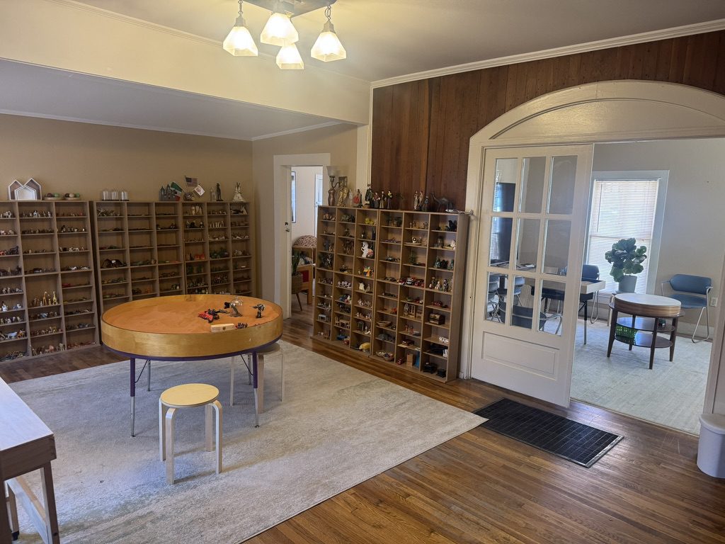 Cozy room with wooden wine racks and a round table.